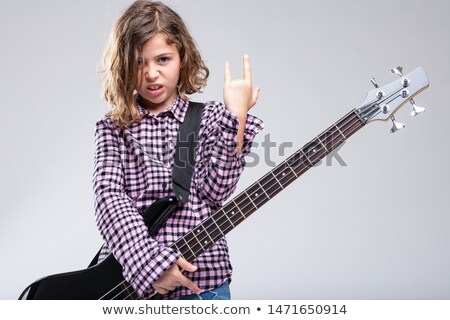 Foto d'archivio: Girl Playing Guitar Giving A Devil Horns Sign