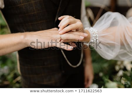 Stock foto: Bride In A White Dress Holding A Bouquet Of Flowers And Greenery