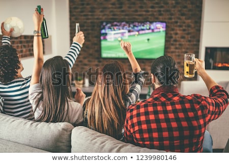 Stock foto: Friends With Beer And Popcorn Watching Tv At Home