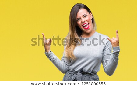 Stok fotoğraf: Hispanic Woman Showing Rock Gesture