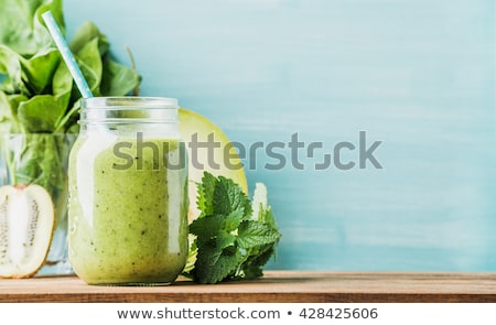 Stockfoto: Freshly Blended Green Kiwi Fruit Smoothie In Glass Jars With Straw Mint Leaf Top View White Woode