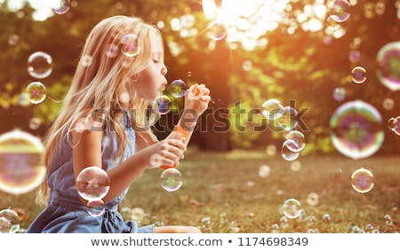 Stock fotó: Young Girl Blowing Bubbles
