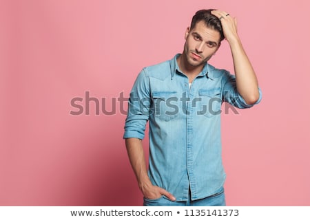 Stock photo: Young Casual Man Fixing Sleeve And Looks To Side
