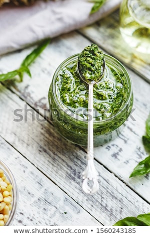 Foto d'archivio: Homemade Pesto Sauce In Glass Jar With Ingredients