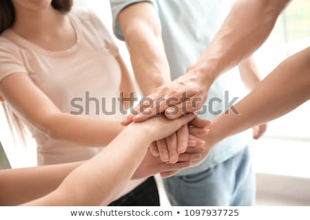Stockfoto: Closeup Of Young Coworkers Putting Hands Together As Symbol Of U