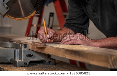 Foto stock: Carpenters With Ruler And Wood Plank At Workshop