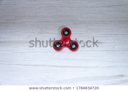 Stockfoto: Colored Fidget Spinners Stress Relieving Toy On Wooden Background