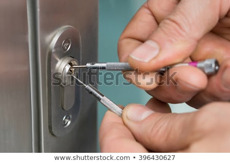 Foto stock: Close Up Of Male Lockpicker Fixing Door Handle At Home