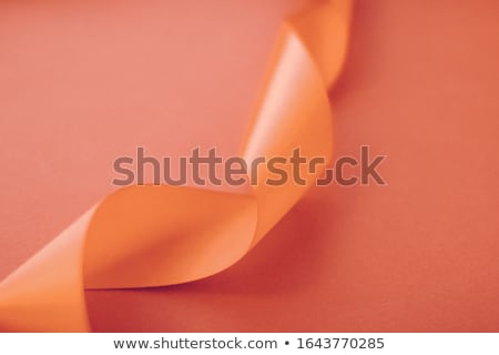 Foto stock: Abstract Curly Silk Ribbon On Orange Background Exclusive Luxur