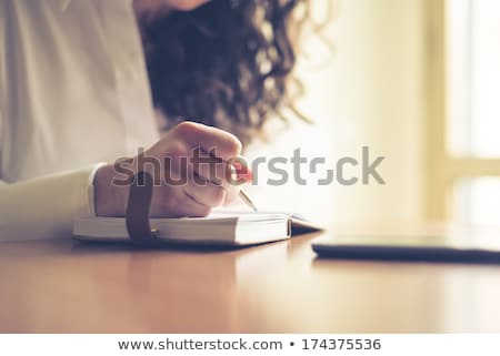 Stock fotó: Brunette Writing In Diary