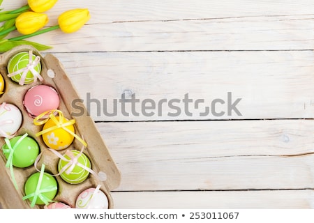 Сток-фото: Pastel Colored Eggs And Beautiful Flowers On A White Background