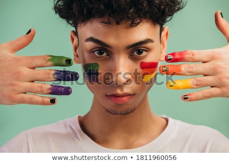 ストックフォト: Man With A Rainbow Flag Painted In His Hand