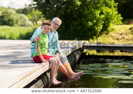 Zdjęcia stock: Grandfather And Grandson Sitting On River Berth