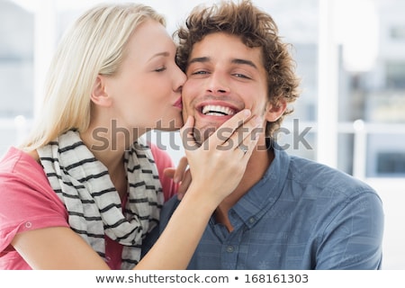 Foto stock: Close Up Portrait Of Woman Kissing Man