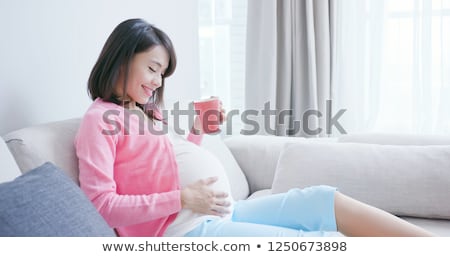 Stock photo: Happy Pregnant Woman With Cup Drinking Tea At Home