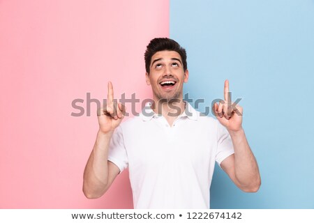 Foto stock: Image Of Joyful Man 30s Having Stubble Pointing Fingers Upward A