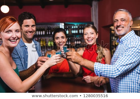 Foto stock: Friends Toasting Tequila Glasses