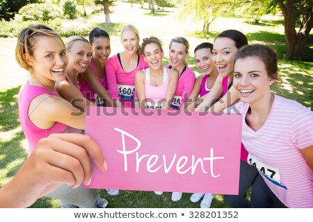 Foto stock: Hand Holding Card With Pink Breast Cancer Awareness Women Marathon Run