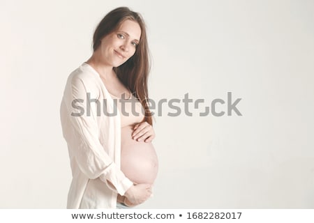 ストックフォト: Happy Pregnant Woman Holding Abdomen