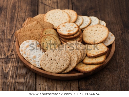 Foto d'archivio: Stack Of Various Organic Crispy Wheat Rye And Corn Flatbread Crackers With Sesame And Salt On Woode