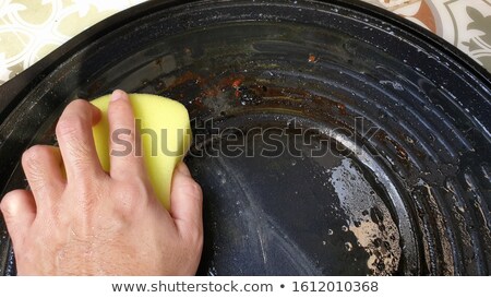 Stock photo: Cleaning Stainless Steel Pan With Steel Pad Brush