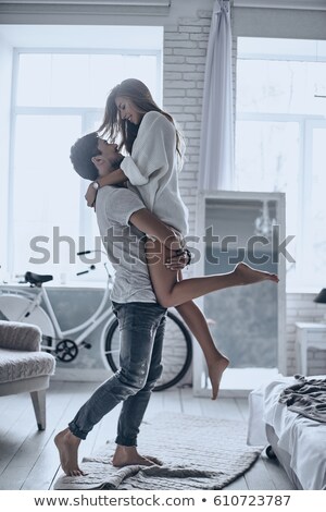 Stock photo: Passionate Casual Young Couple Standing Embraced