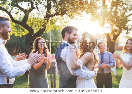 Foto stock: Guests Clapping For Newly Married Couple