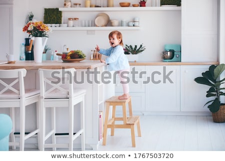 Stock fotó: Toddler Girl On Chair At Counter