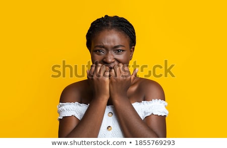 Foto d'archivio: Shocked Emotional African Woman Posing Isolated Over Yellow Background Using Mobile Phone