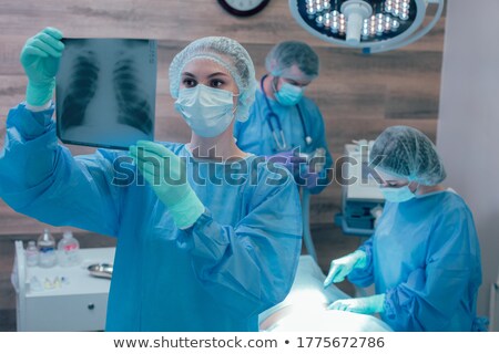 Stockfoto: Confident Young Female Surgeon Holding A Stethoscope
