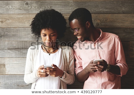 Stock photo: Young Woman Looking Down At Cell Phone