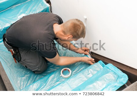 Stock fotó: Worker Covering Stairs Carpet With Masking Film Before Home Impr