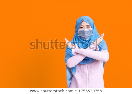 Stockfoto: Muslim Woman In Hijab Showing Stop Sign