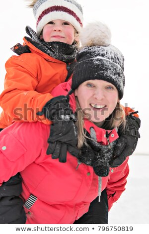 Stock foto: Mother And Son On His Back In Snowy Landscape