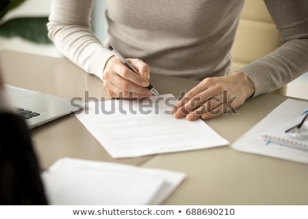Foto stock: Womans Hand Filling Mortgage Application Form