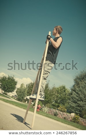 Stock fotó: Teenage Boy On Stilts