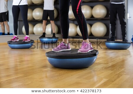 Foto d'archivio: Low Section Of Class With Exercise Balls At Fitness Studio