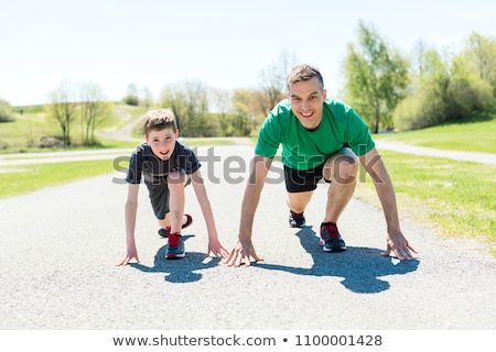 Foto stock: Parents With Children Sport Running Together Outside