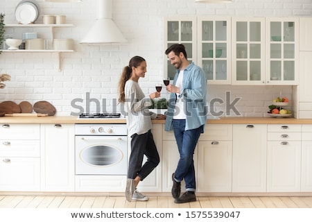 Stock foto: Smiling Lovers Drinking White Wine In The Kitchen