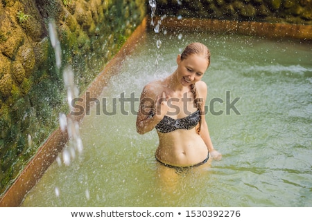Stock photo: Thermal Water Is Released From The Mouth Of Statues At A Hot Springs In Banjar Bali Indonesia