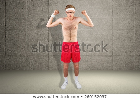 Foto stock: Geeky Shirtless Hipster Flexing Biceps