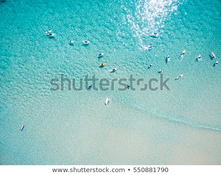 ストックフォト: An Aerial View Of Surfers Waiting For A Wave In The Ocean On A Clear Day