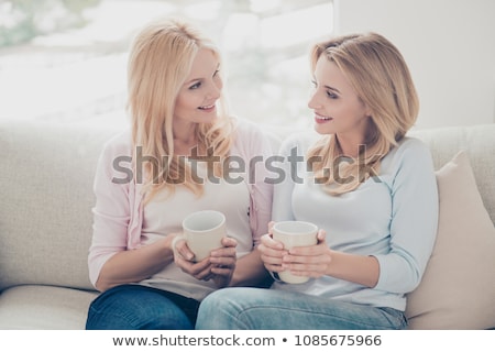 Stockfoto: Happy Female Friends Drinking Cacao At Home