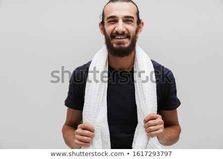Stock foto: Image Of Bearded Sportsman With Towel Over His Neck Smiling Afte