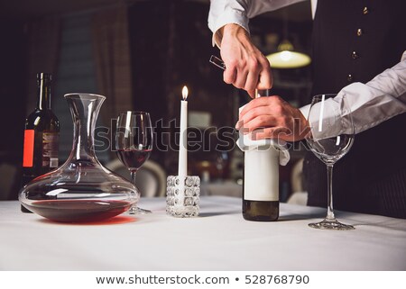 Zdjęcia stock: Man Opening A Red Wine Bottle