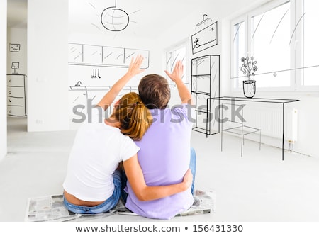 Stock fotó: Happy Couple At Empty Room Of New Home