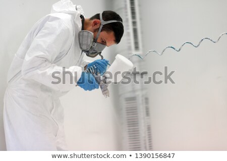 Stockfoto: Worker Using Air Brush To Paint Metal