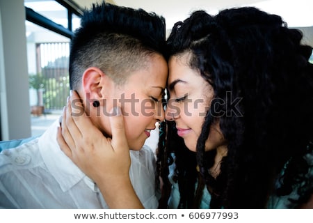 Foto d'archivio: Close Up Of Happy Lesbian Couple Hugging At Home