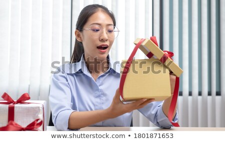 ストックフォト: Woman Receving Cloth In Dressing Room