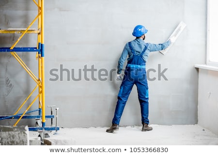 Stockfoto: Plaster Worker On Scaffold Working